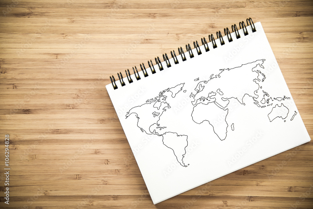 World map outline on notebook World map outline on notebook