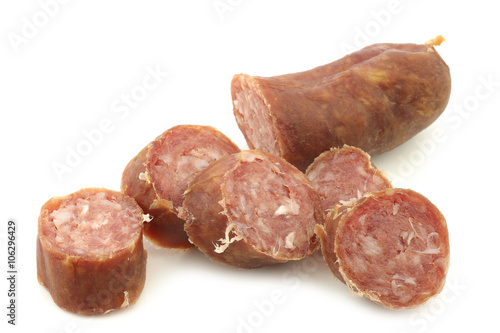 cut pieces of traditional frisian smoked and dried sausages on a white background 