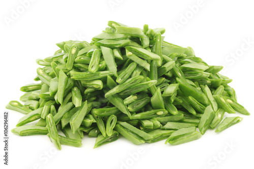 freshly cut string beans ready for cooking in a metal colander on a white background

