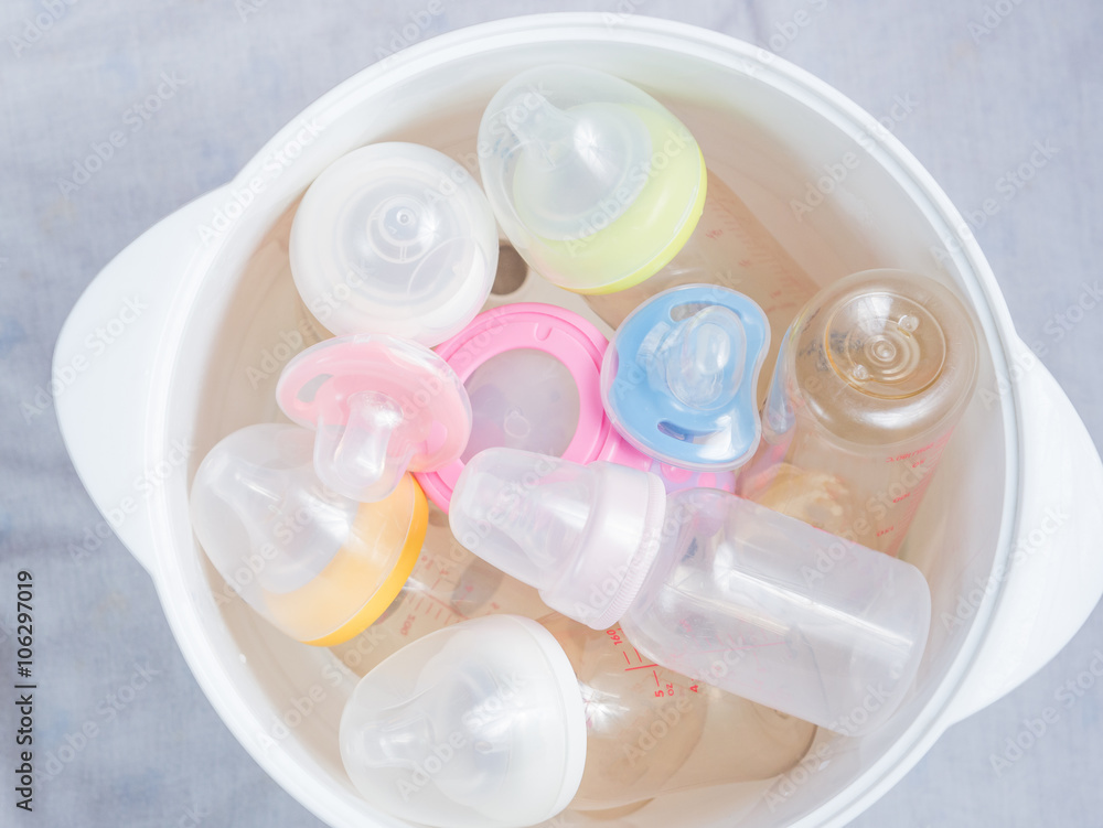 Nipple teethers and milk bottles in steam sterilizer and dryer. Nipple teethers and milk bottles in steam sterilizer and dryer.