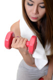 Woman is exercising with dumbbell.