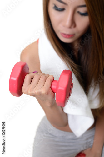 Woman is exercising with dumbbell.