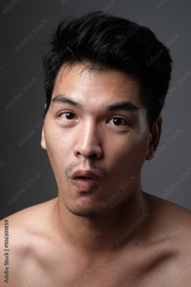 Asian man portrait with no makeup show his real skin in grey background - soft focus Asian man portrait with no makeup show his real skin in grey background - soft focus