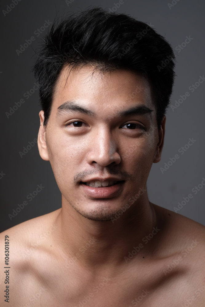 Fototapeta premium Asian man portrait with no makeup show his real skin in grey background - soft focus