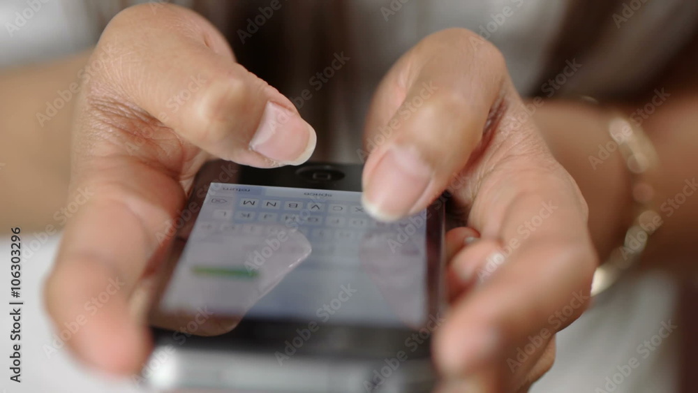 Hands of a young girl texting with her smartphone Hands of a young girl texting with her smartphone