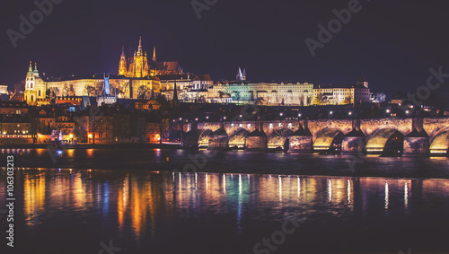 Castle, Charles Bridge and Vltava river, Night panorama of Prague, Czech Republic, vintage effect