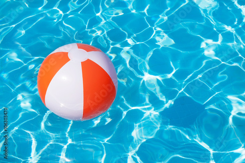 Colorful beach ball floating in a pool