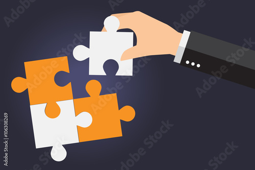 Business people solving oversized jigsaw puzzle together