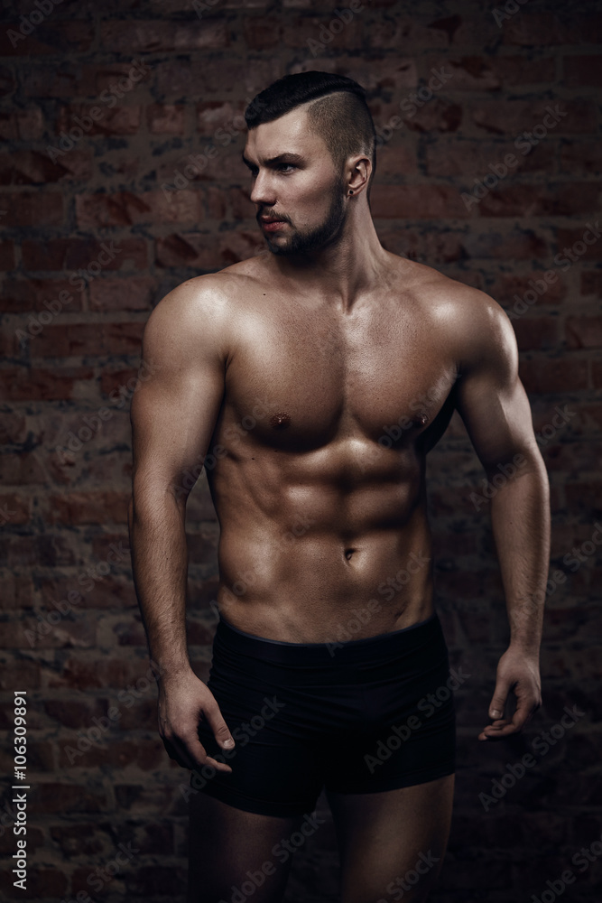 Fototapeta premium Young muscular man posing