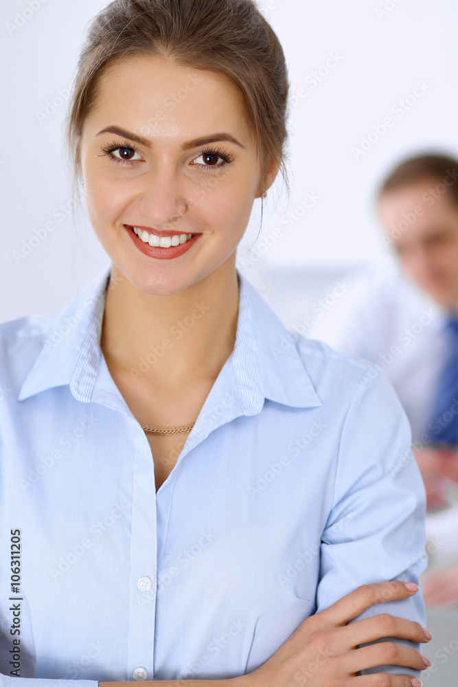 Beautiful business woman on the background of business people during meeting Beautiful business woman on the background of business people during meeting