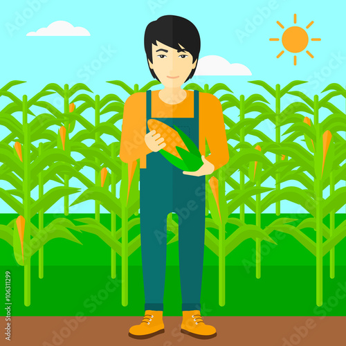 Farmer holding corn.