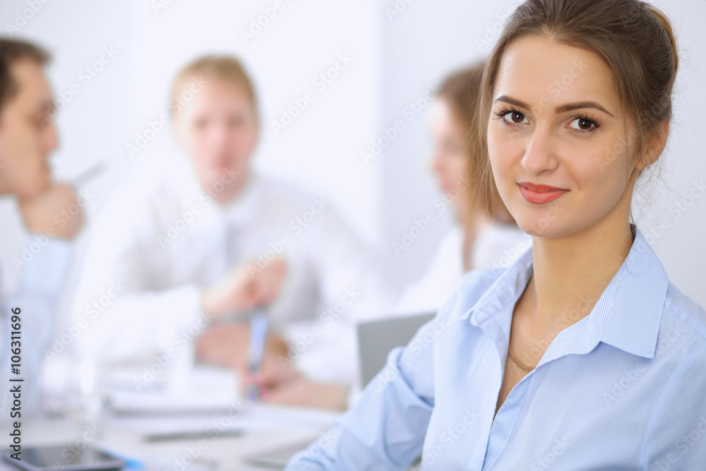 Beautiful business woman on the background of business people during meeting Beautiful business woman on the background of business people during meeting
