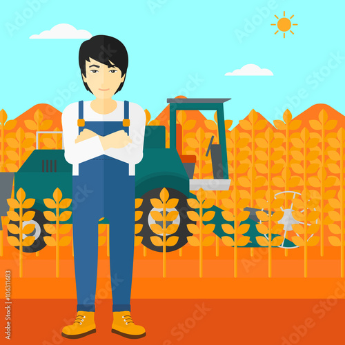 Man standing with combine on background.