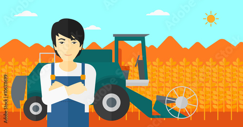Man standing with combine on background.