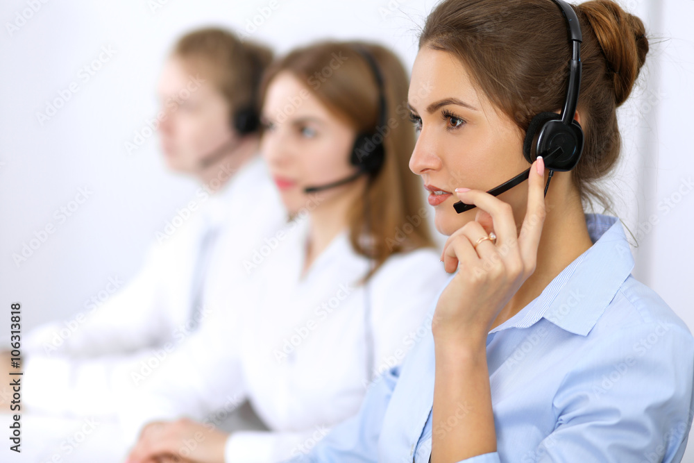 Call center. Focus on beautiful woman in headset Call center. Focus on beautiful woman in headset