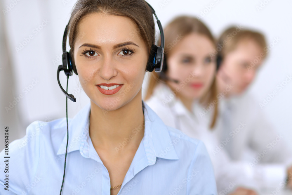 Call center. Focus on beautiful woman in headset Call center. Focus on beautiful woman in headset