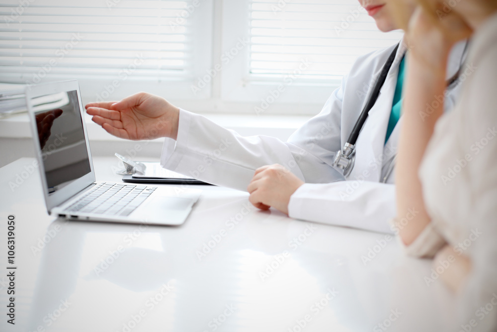Doctor and patient are discussing something, just hands at the table Doctor and patient are discussing something, just hands at the table