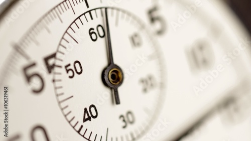 Stopwatch time lapse. A stop watch clockwork clock face timelapse with selective focus and limited depth of field.