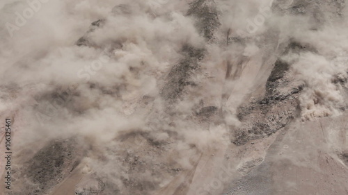 A massive cloud of dust and debris erupts from a steep mountain slope during an earthquake-triggered landslide in Tungurahua province, Ecuador, seen from a high angle over the rugged terrain.