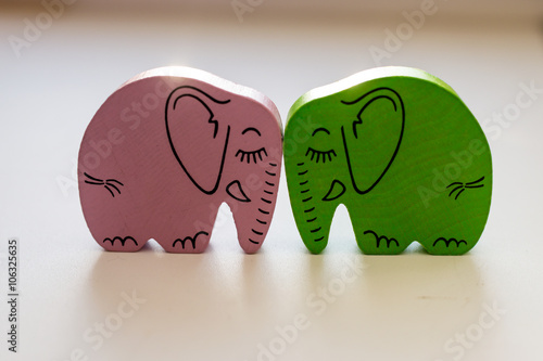 Pink and Green Wooden Elephants Touching Heads