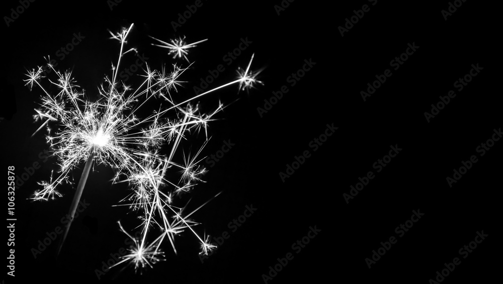 Fototapeta premium Christmas sparkler on black background. Bengal fire