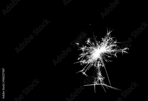 Christmas sparkler on black background. Bengal fire