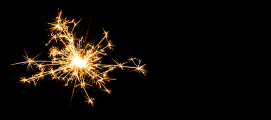 Christmas sparkler on black background. Bengal fire