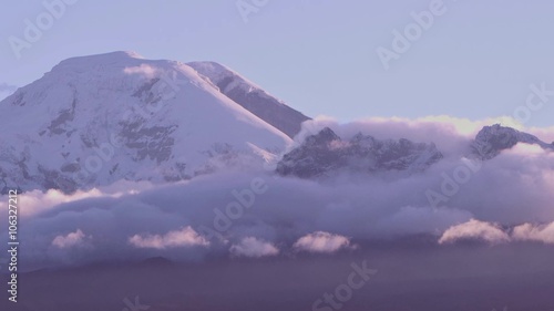 Experience the breathtaking beauty of a time lapse zoom over the majestic Chimborazo volcano in Ecuador,capturing the mesmerizing sunset.