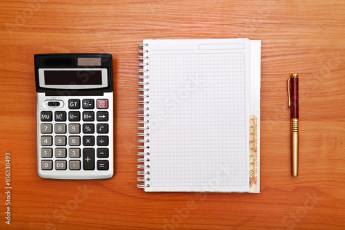 Business concept with pen, notebook and calculator