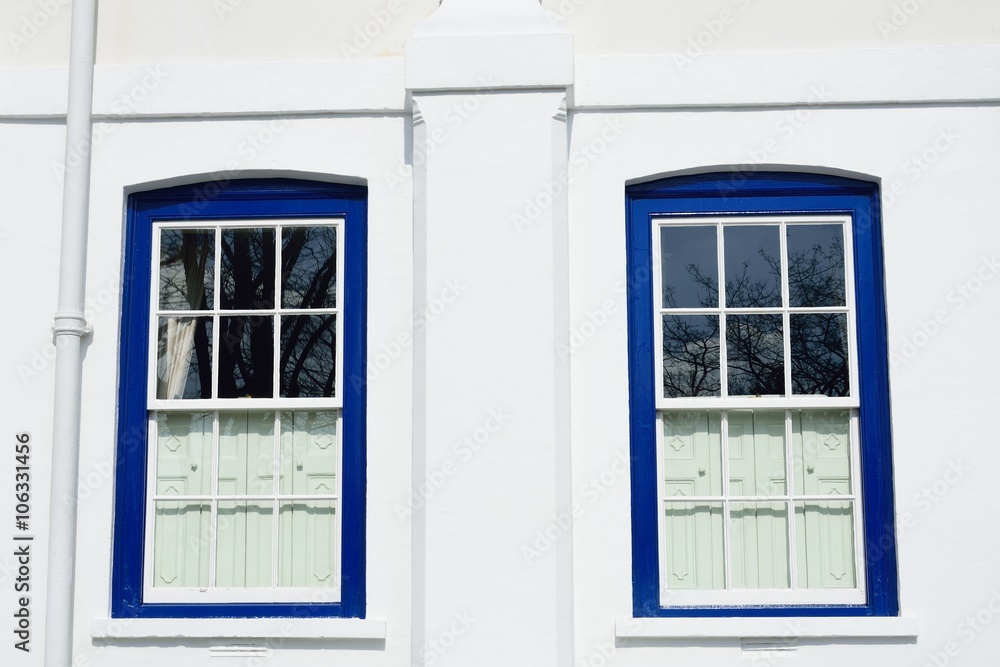 Fototapeta premium Traditional Blue windows on white walls