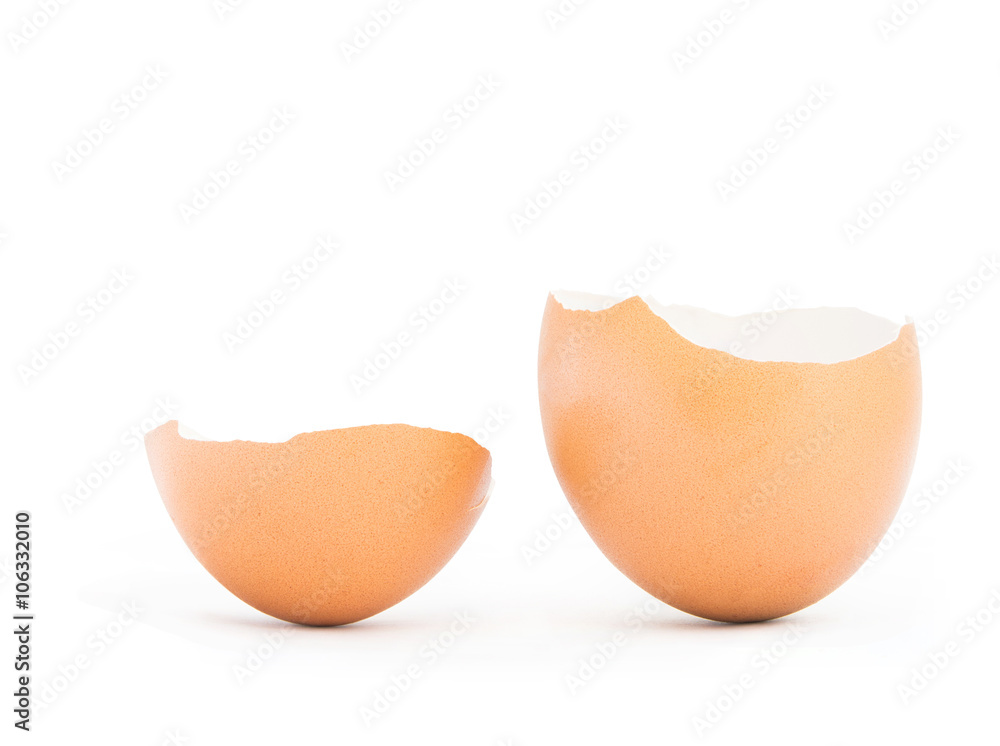 Brown egg cracked or broken on white background