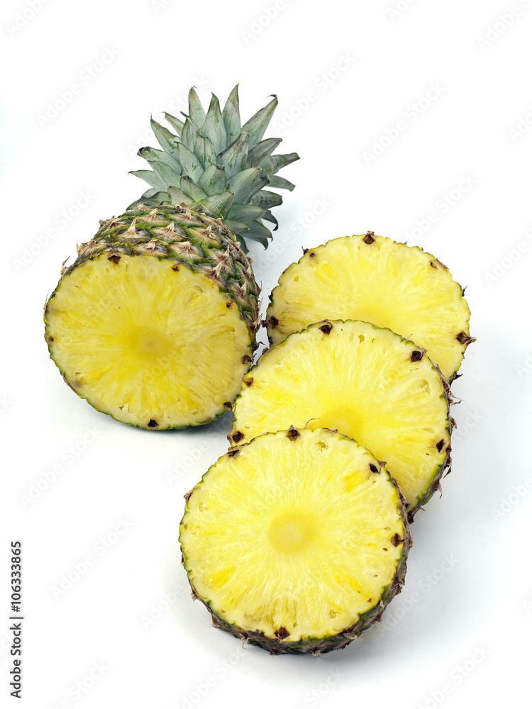 pineapple top and slices on white pineapple top and slices on white
