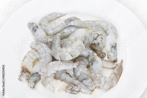 Quadro em tela Raw peeled shrimp on white dish on white background.