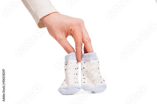 hands of happy pregnent woman holding child socks  photo