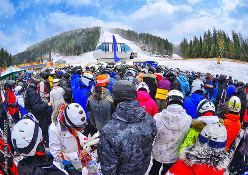Bilde på lerret People stand before ski lift in queue in Bukovel , Ukraine