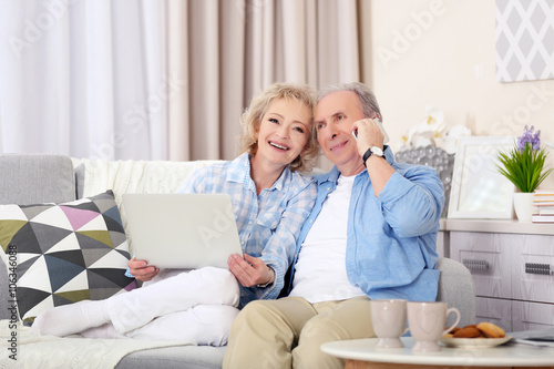 Mature couple using laptop ...