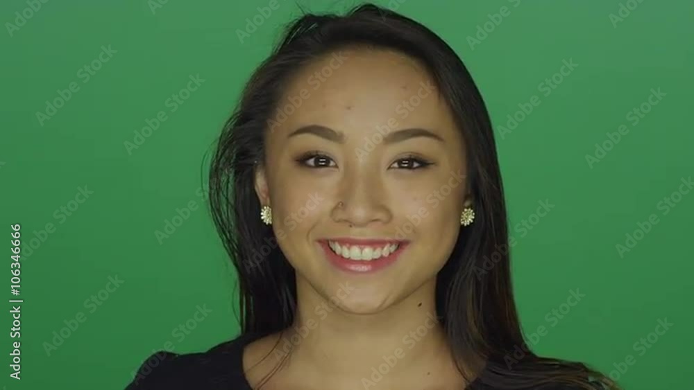 Beautiful young woman smiling, on a green screen studio background Beautiful young woman smiling, on a green screen studio background