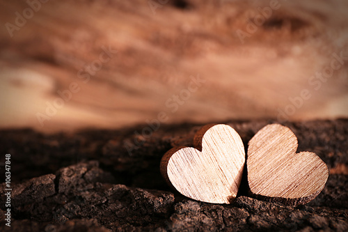 Valentine concept. Two love hearts on wooden background