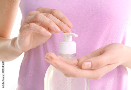 Woman using liquid soap, closeup