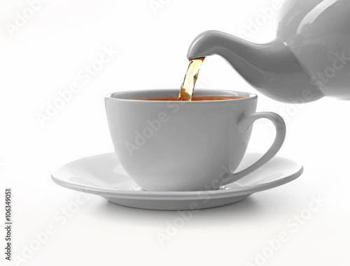 Cup of tea and teapot, isolated on white