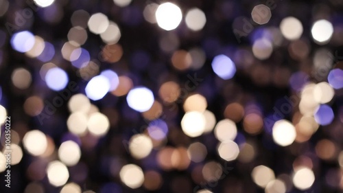 Abstract glittering lights, silver background, a real shot video in the blur