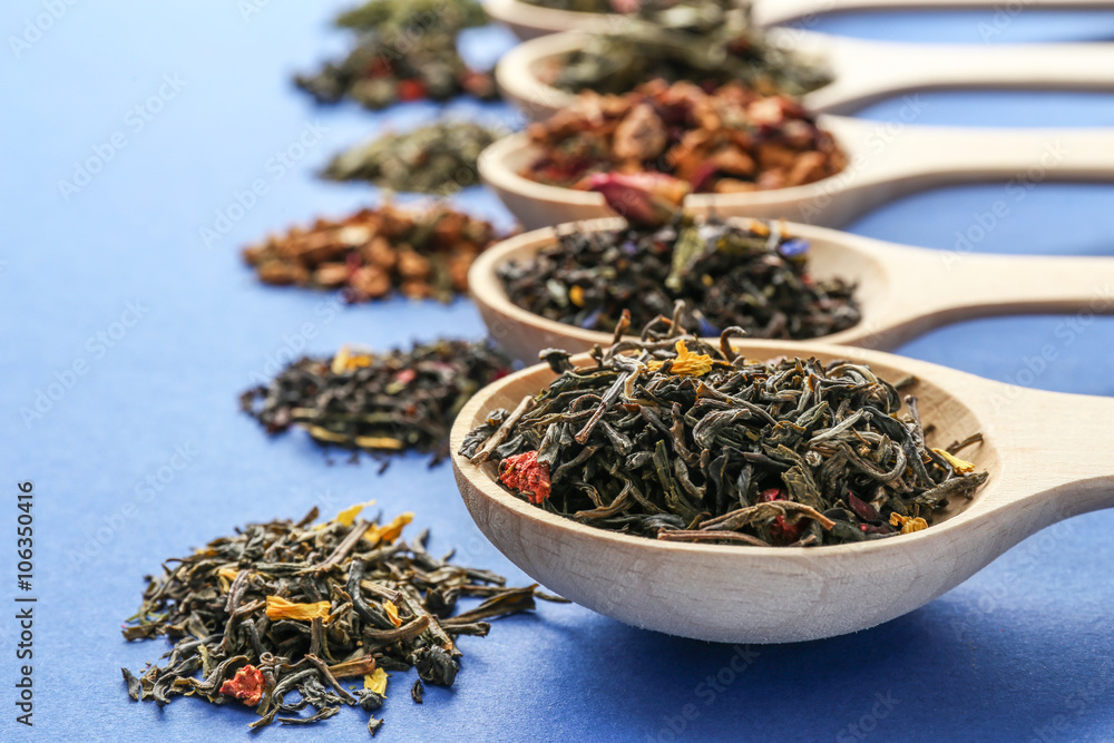 The different kinds of tea presented as a sample in the white spoons, close up The different kinds of tea presented as a sample in the white spoons, close up
