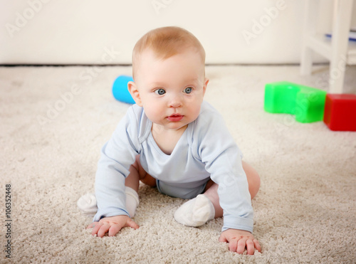 Cute baby with plastic toys...