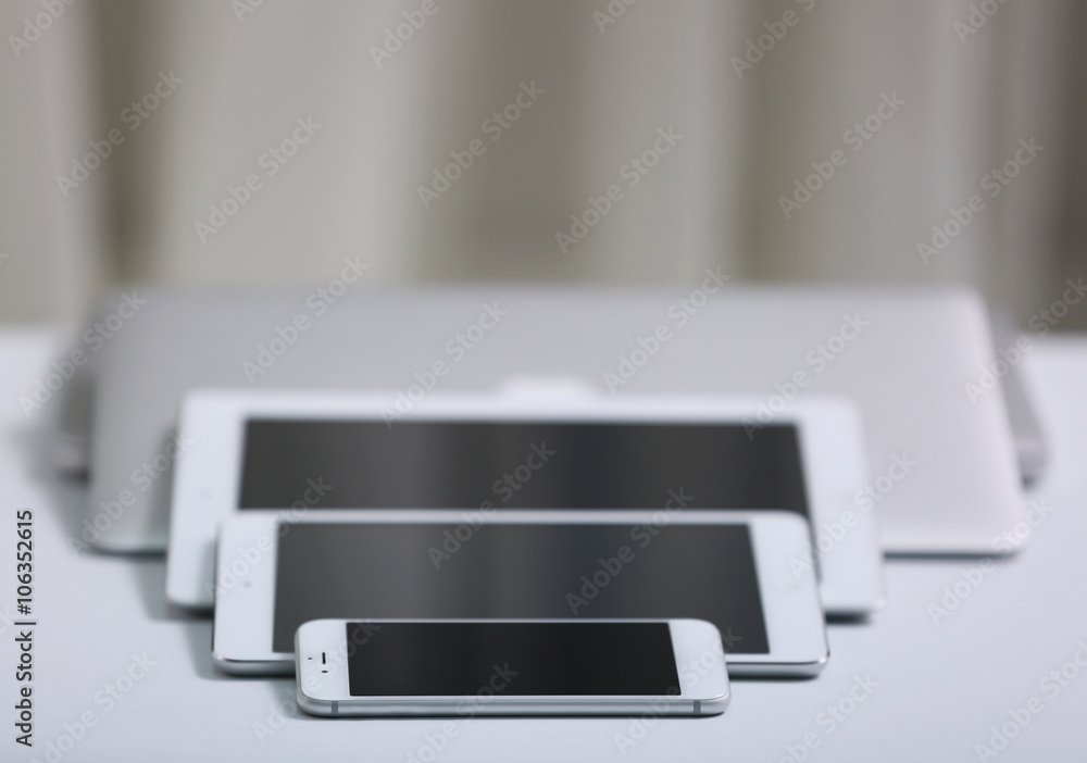 A set of electronic devices on a white desk A set of electronic devices on a white desk