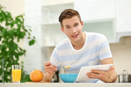 Handsome man with tablet an...