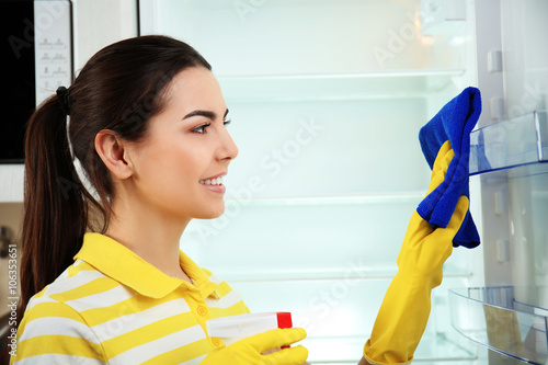 Woman washing refrigerator ...