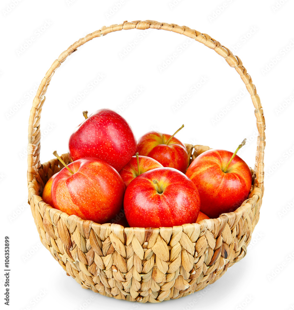 Wicker basket with red juicy apples isolated on white background Wicker basket with red juicy apples isolated on white background