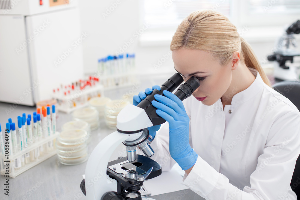 Skillful female researcher is using modern equipment Skillful female researcher is using modern equipment