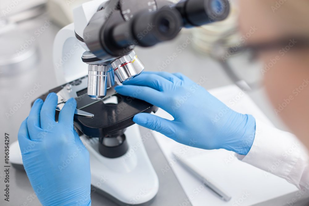 Cheerful young scientist is doing her research Cheerful young scientist is doing her research
