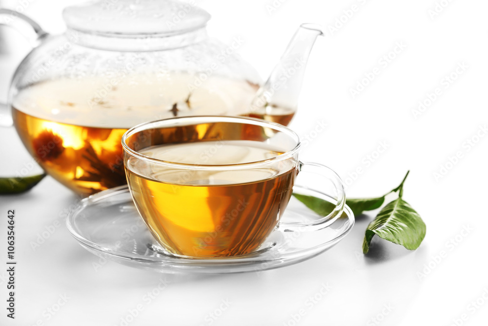 Cup of tea and teapot isolated on white Cup of tea and teapot isolated on white